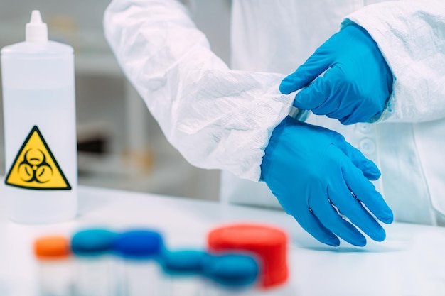 Woman Putting Protective Splash Face Shield On Laboratory Safety Equipment