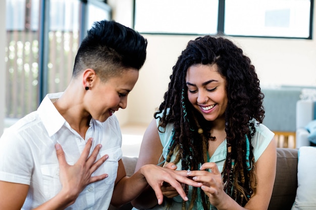 Woman putting a surprise ring on her partners finger