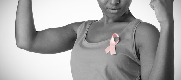 Woman putting up fists and looks at pink ribbon