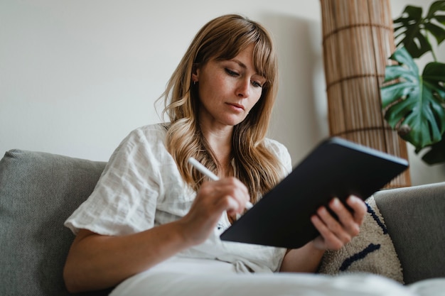 Woman in pyjamas working at home during coronavirus outbreak