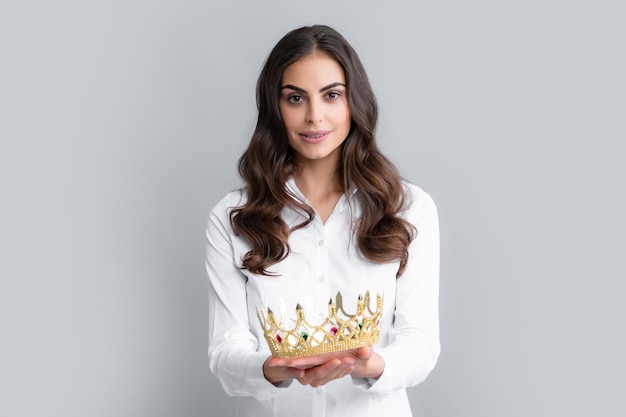 Woman queen Portrait of ambitious girl with crown feeling princess confidence Studio shot isolated on gray background