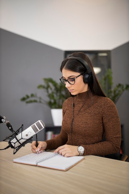 Woman in a radio studio with headphones and microphone