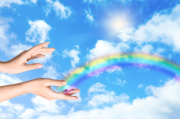 Woman and rainbow as source of healing energy on sunny day closeup