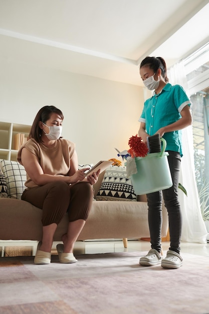 Woman rating work of cleaning serivce worker