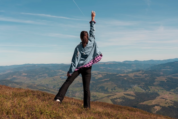 Woman reached the top of mountain and celebrating