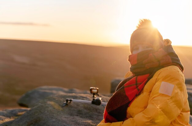 Woman reaching destination  on top of hill or mountain at sunrise  Local tourism concept