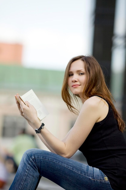 Woman read book and look at you