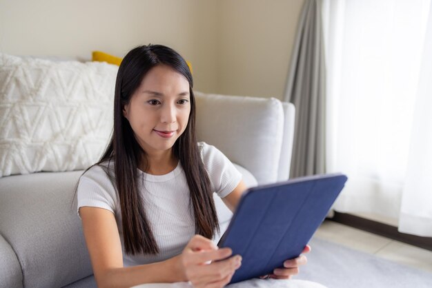 Woman read on tablet computer at home