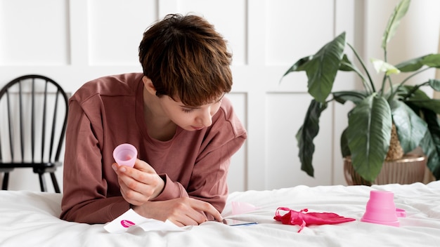 Photo woman reading about menstrual cup medium shot