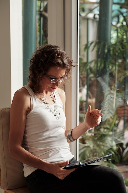 Woman Reading Article on NFT and Cryptocurrency