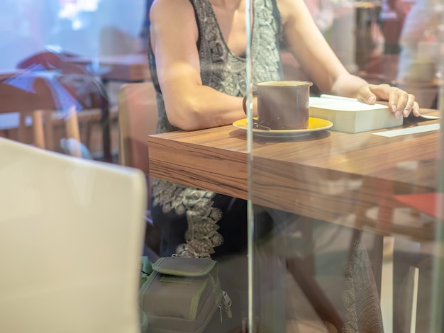 Woman reading book in cafe