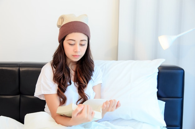 woman reading a book on her bedroom. concept for healthy and learning.