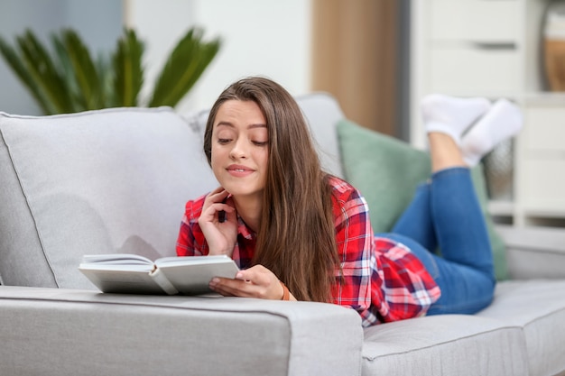 Woman reading a book at home