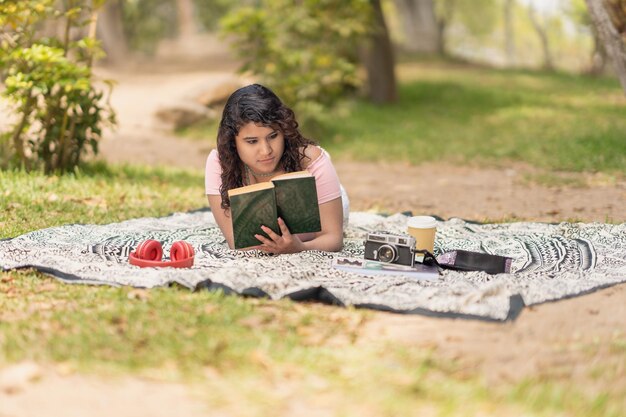 Woman reading a book in a park