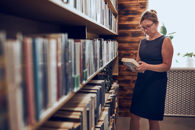 Woman reading book in public library reading and learning benefits of everyday reading bookstore