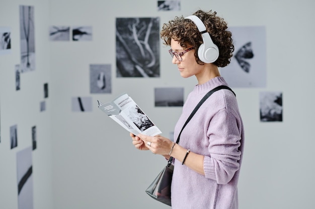 Woman reading booklet at gallery