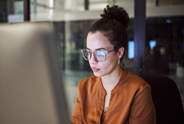 Photo woman reading and glasses reflection in office at night working on computer email or planning business schedule female worker pc tech screen and overtime web research in dark company workplace