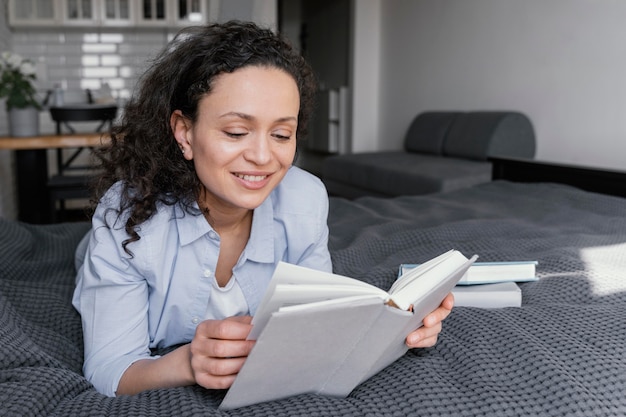 Woman reading indoors full shot