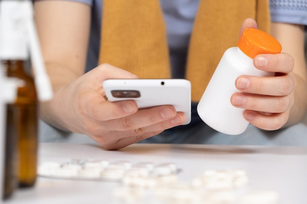 Woman reading instructions for the use of medication on the Internet using a smartphone Online appointment with a doctor