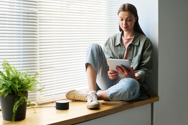 Woman reading online book on tablet pc