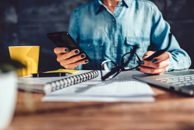 Woman reading text message on smart phone