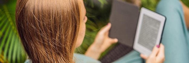 Woman reads ebook on deck chair in the garden banner long format