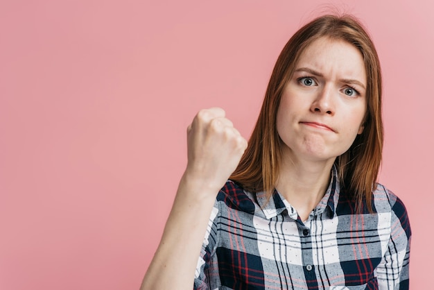 Woman ready to fight with pink background