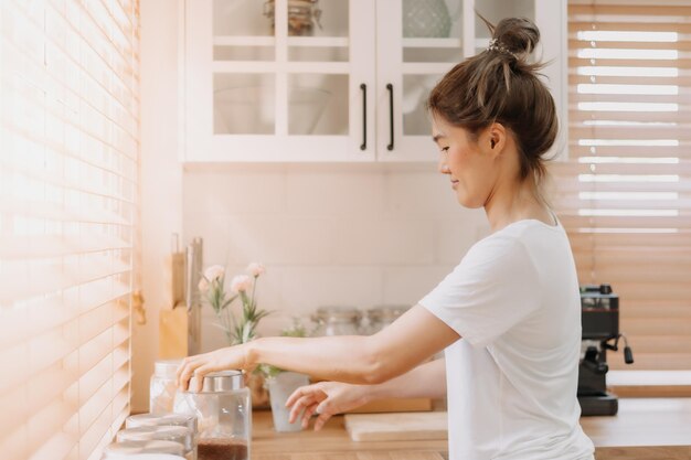 woman rearrange equipments items and cleaning the kitchen
