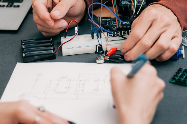 Woman recapping electronics creation process