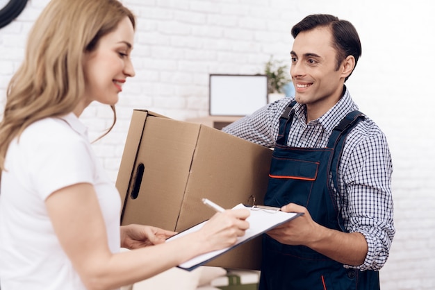 Woman received the parcel from the delivery worker.