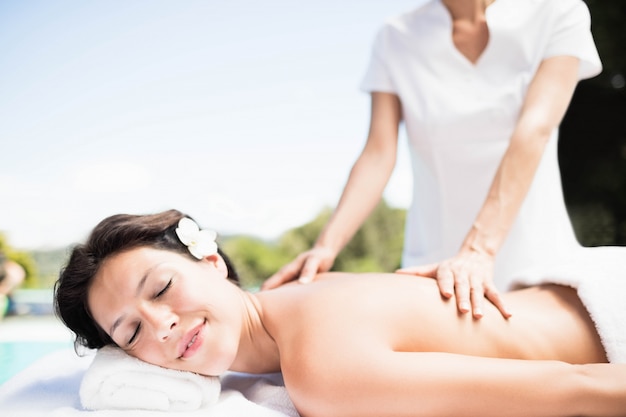 Woman receiving a back massage from masseur in a spa