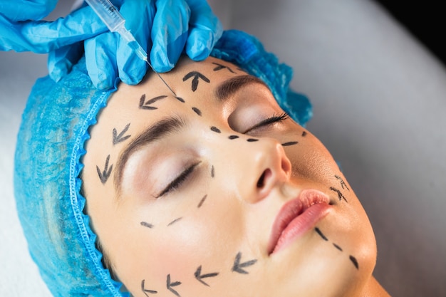 Woman receiving injection on her forehead