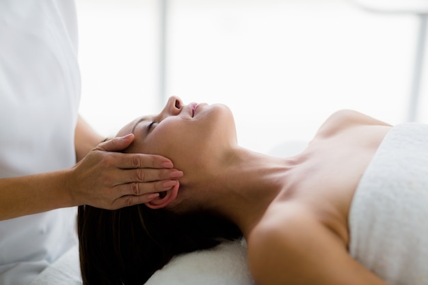 Woman receiving massage from masseur