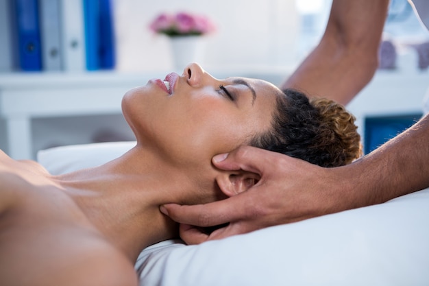 Woman receiving neck massage from physiotherapist