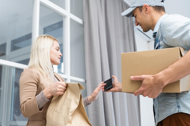 Woman receiving package from delivery man