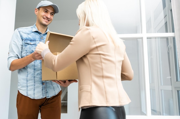 Woman receiving package from delivery man