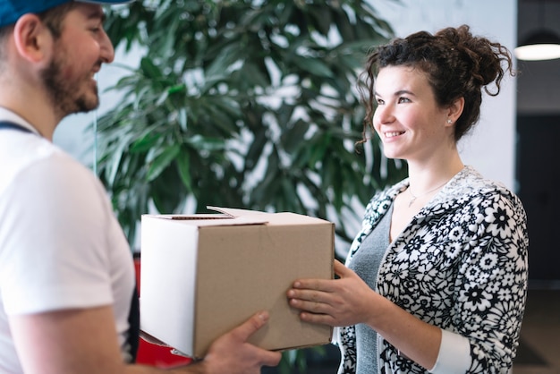 Woman receiving package with courier