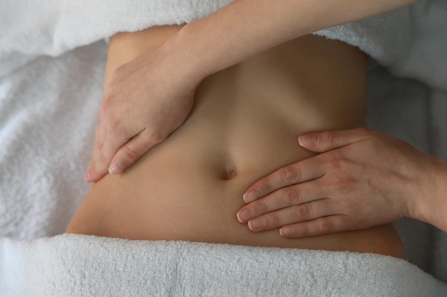 Woman receiving professional belly massage closeup view