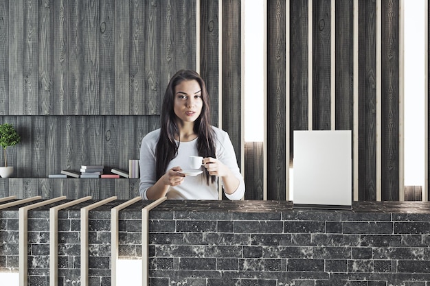 Woman at reception drinking coffee