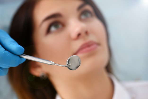 woman at the reception of a male dentist examining teeth