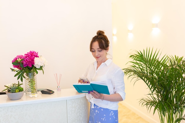 Woman Receptionist Reception Workplace Workplace in Beauty Salon White Interior