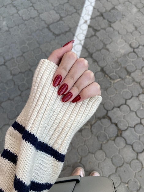 Woman red aesthetic nail design on a grey background