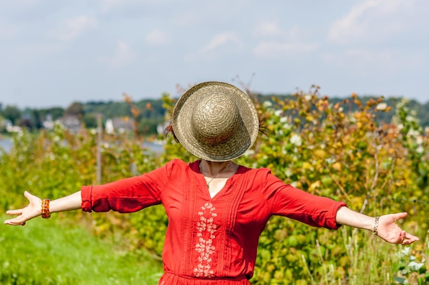 Woman in red dress against sky