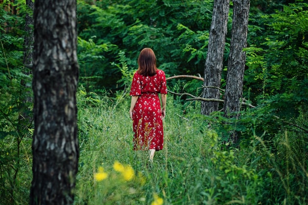 Woman in red dress enjoying nature nature therapy ecotherapy practice of being in nature to boost