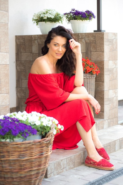 Woman in red dress in garden