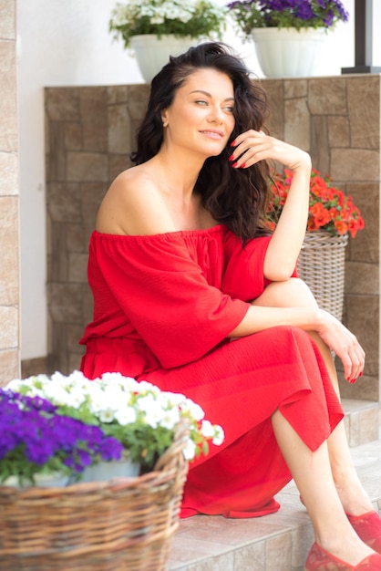 Woman in red dress in garden