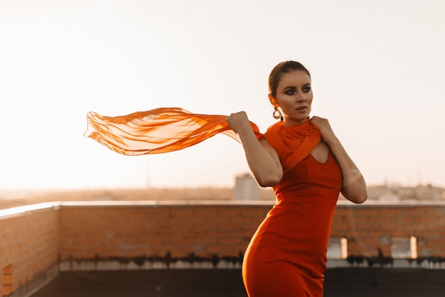 woman in a red dress at sunset