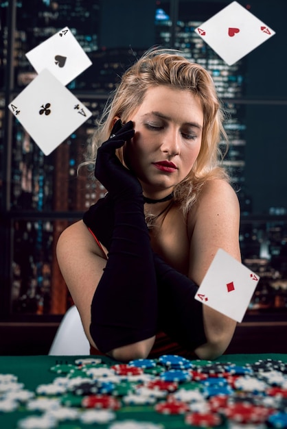 Woman in red dress throw fly playing cards in casino game Gambling concept Cards flying in air fall