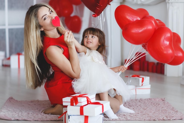 woman in red dress with heart in hands