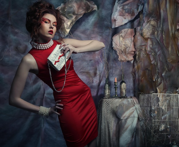 Woman in red dress with white handbag